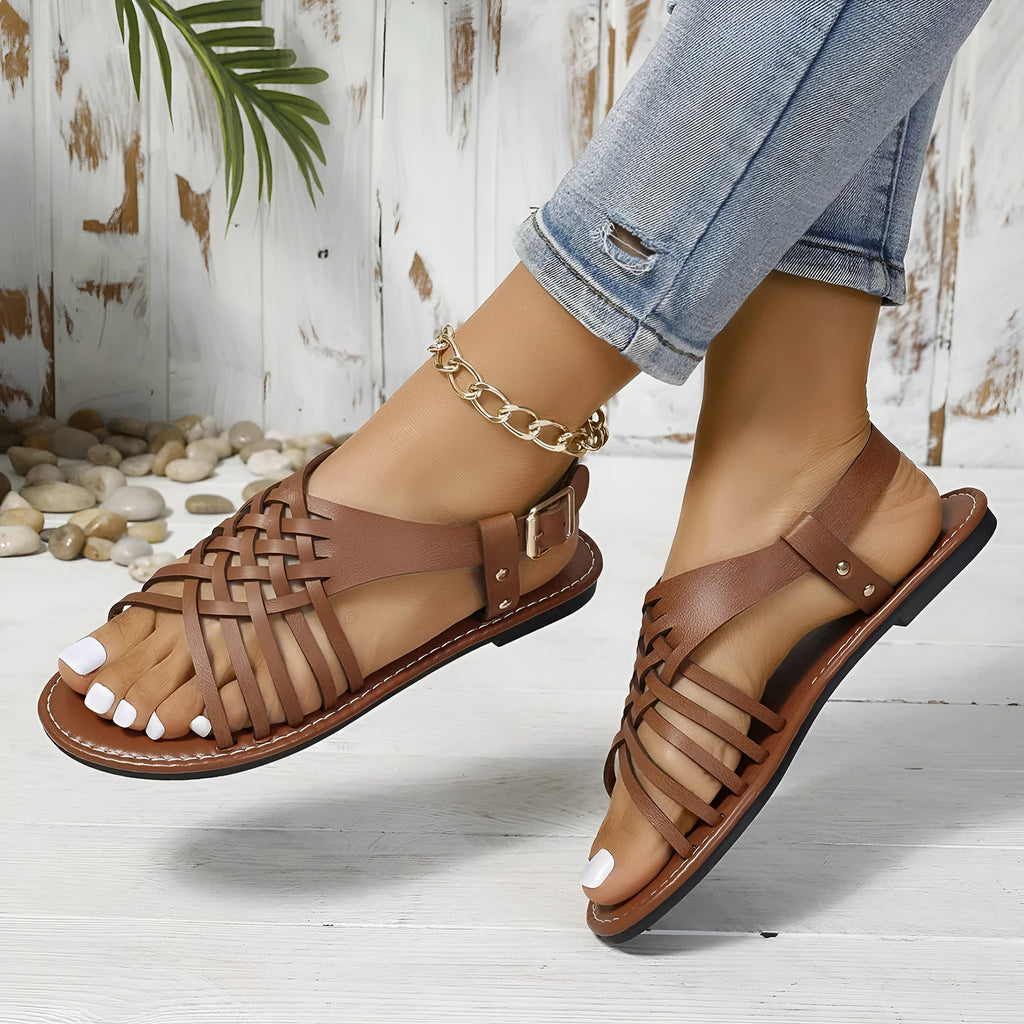 Roman style beach slippers with cross strap design and adjustable flat buckle in black