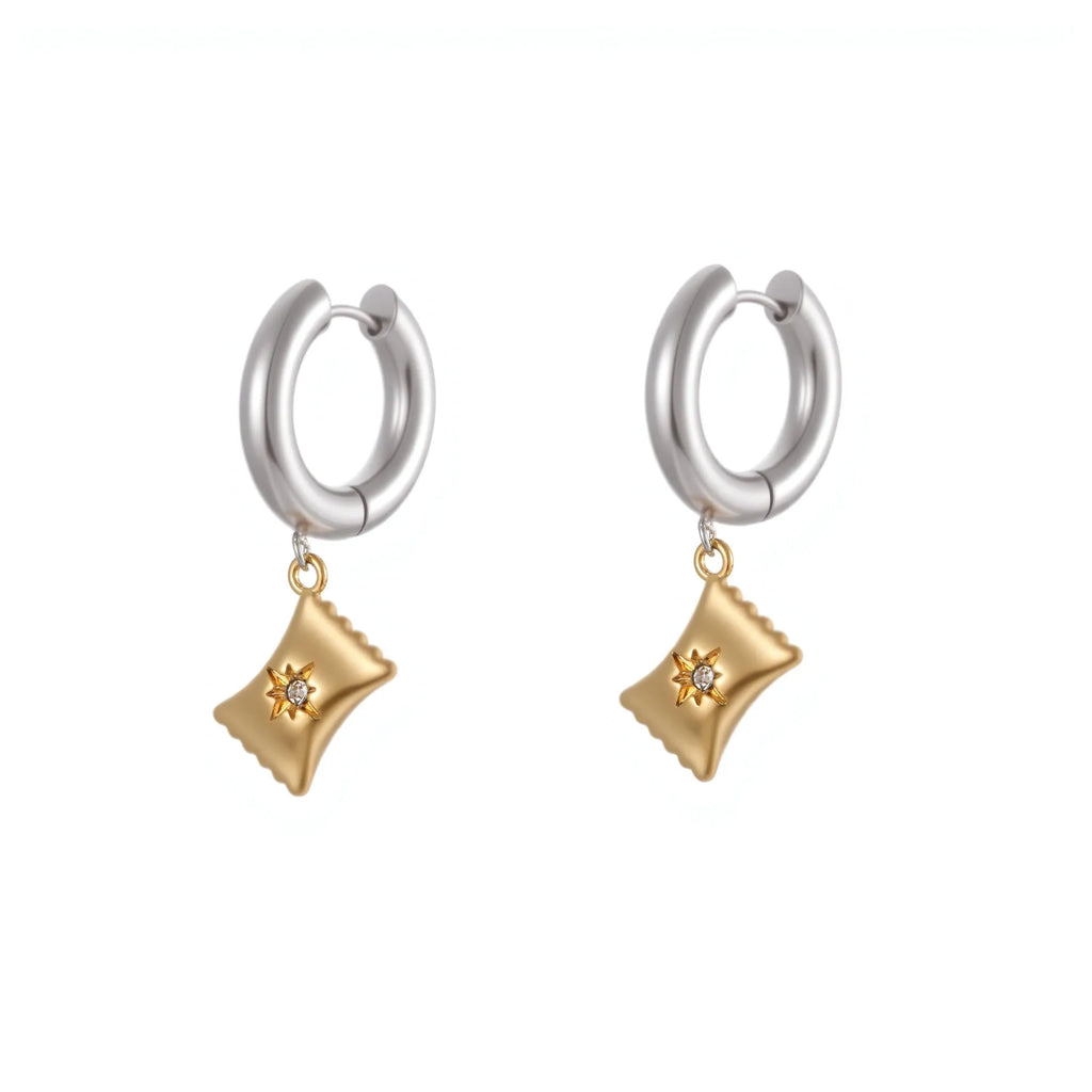 A pair of stainless steel earrings with 18K gold plating in a Christmas tree and heart shape design.
