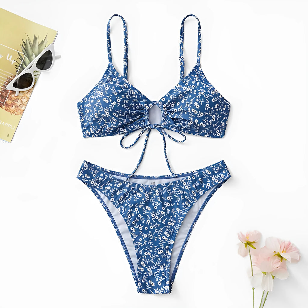 Blue women's swimsuit three-piece set showing separate top and shorts on a neutral background.