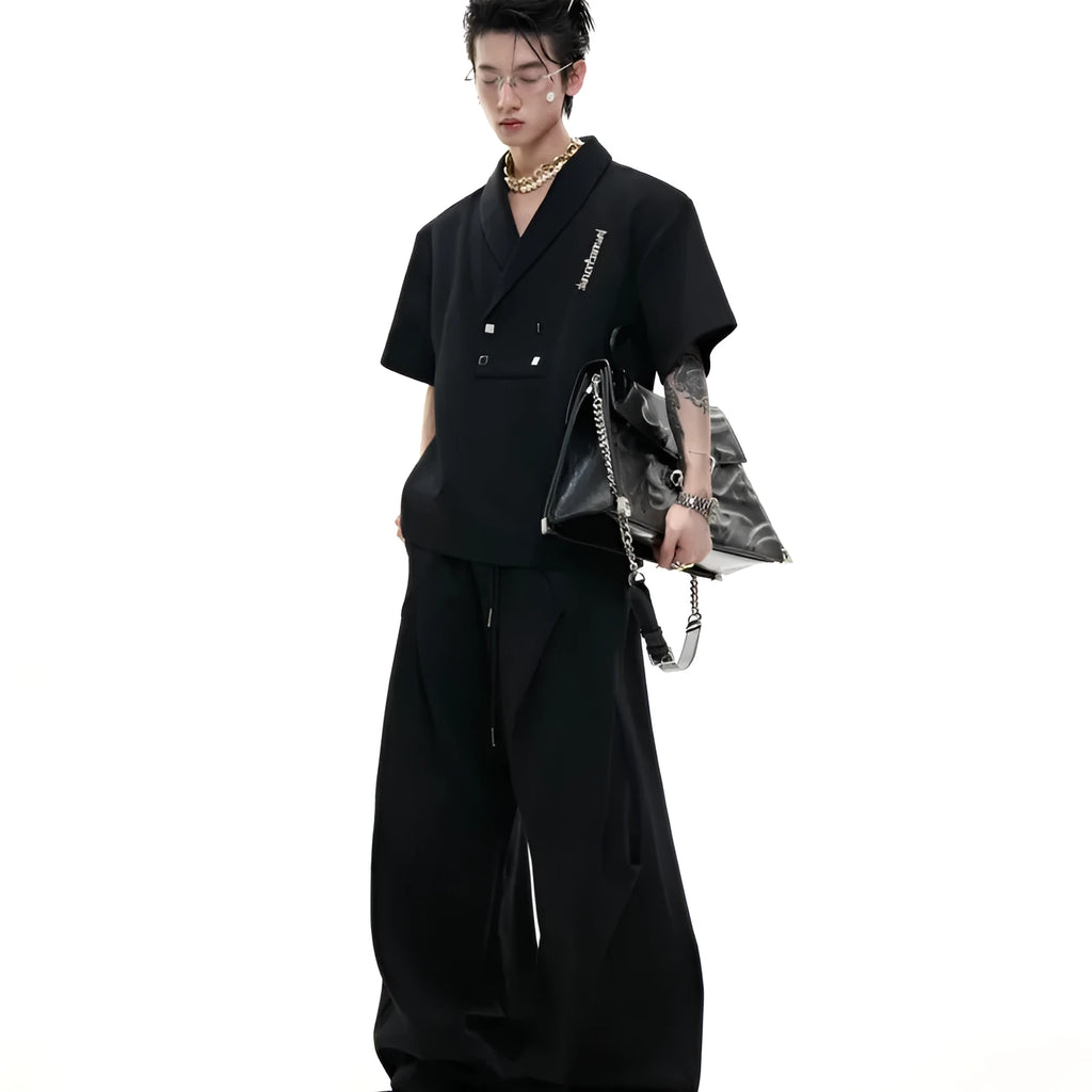 Men's dark grey V-neck cotton sports suit with padded shoulder jacket and matching shorts.