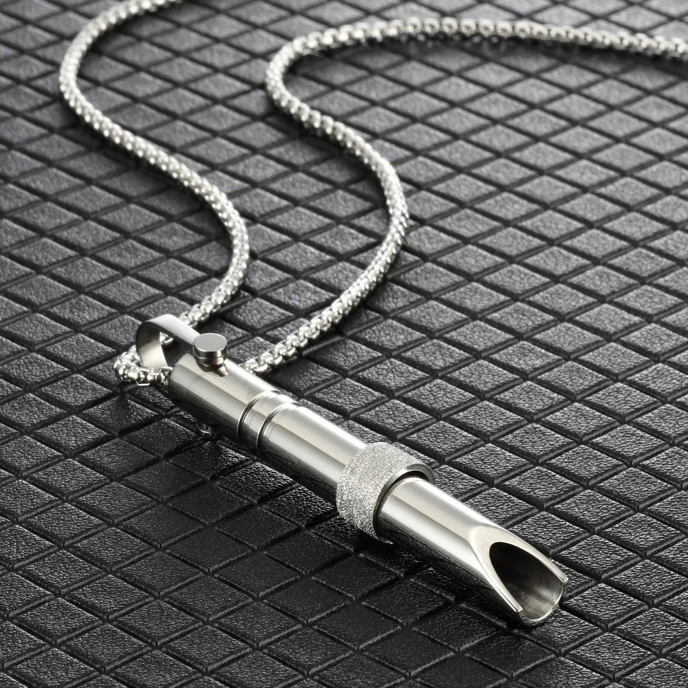 Therapeutic stainless steel breathing pendant with spinner mechanism and Braille text, designed for natural anxiety relief