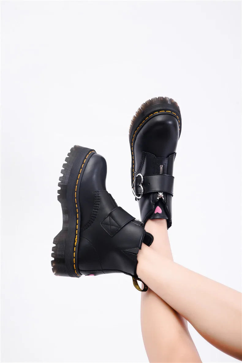 Women's black leather ankle boots with chunky heel, lace-up front, side zip, and belt buckle detail on a waterproof platform