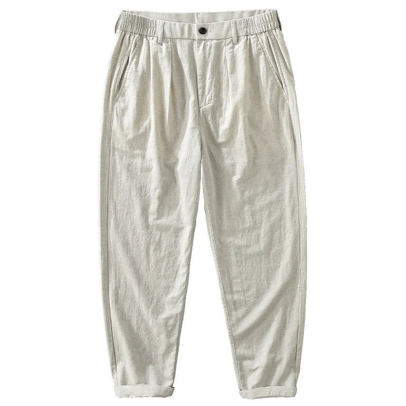 Man wearing loose straight-leg cotton linen trousers in a solid earthy colour.