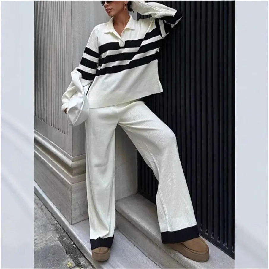 Women's black and white striped knitted polo shirt with matching trousers, a casual two-piece set.