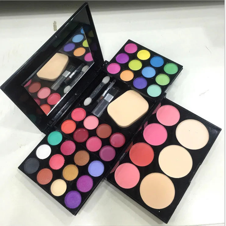 Three-layer makeup box set with 24 eyeshadow colours, 8 lipsticks, blushes, powder cakes, brushes, puff, and mirror