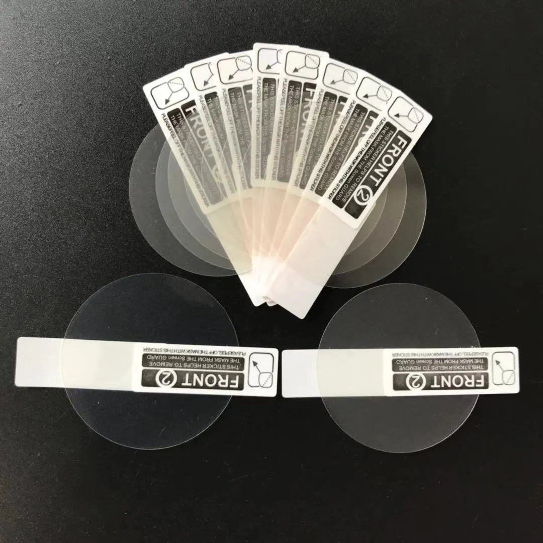 Three transparent PET screen protector films for Ticwatch2 smartwatch on a clean surface.