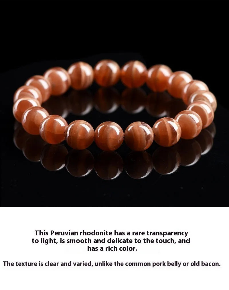 Natural old mine rhodochrosite round bead bracelet on wrist, showing geometric design and Ruyi symbol.