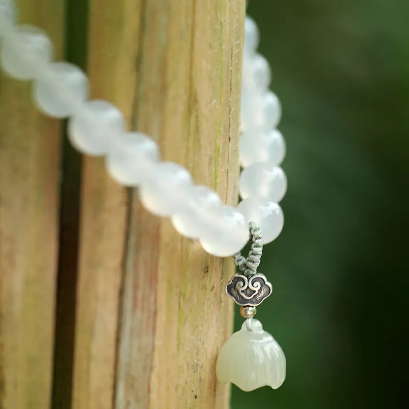 S925 silver bracelet with white agate and Hetian jade stones forming a geometric lotus design.