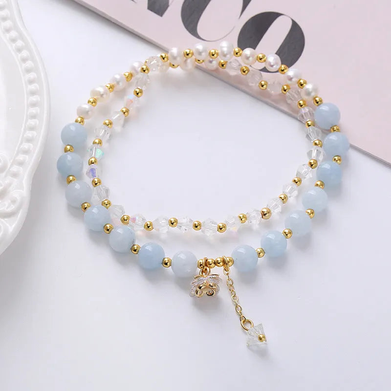 Women's double ring bracelet with crystal charms in choice of strawberry quartz, amethyst, or aquamarine colour.