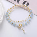 Women's double ring bracelet with crystal charms in choice of strawberry quartz, amethyst, or aquamarine colour.