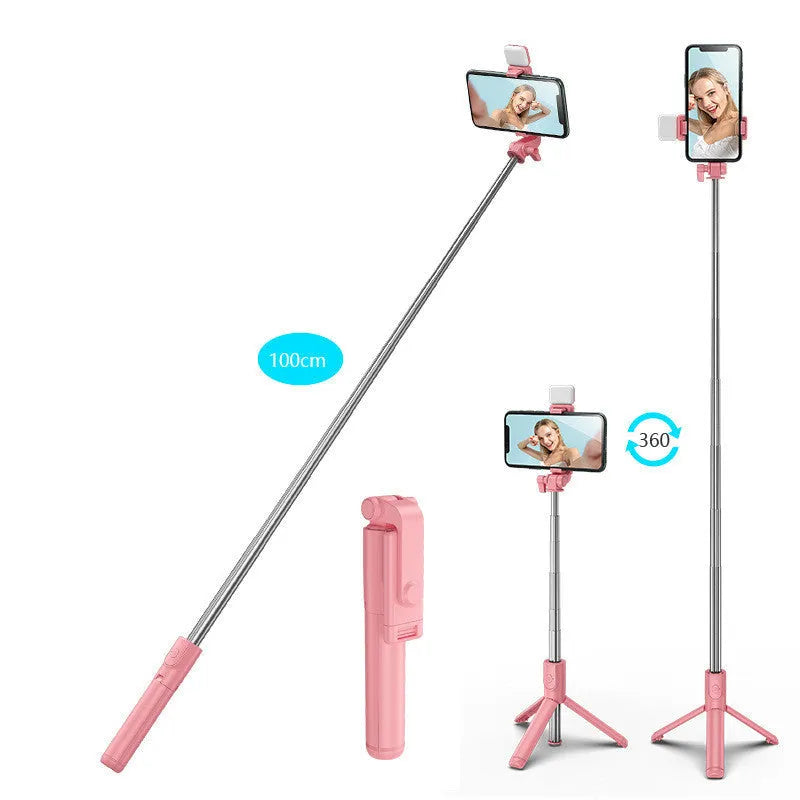 Black Bluetooth selfie stick tripod with fill light extended, holding a smartphone.