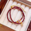 Women's double ring bracelet with natural red garnet beads and adjustable clasp.