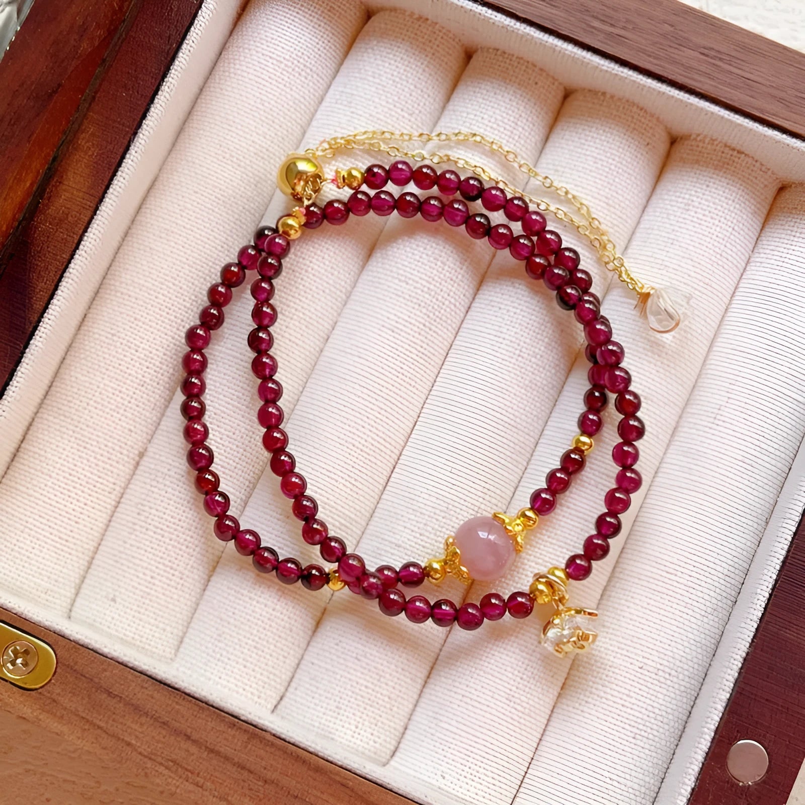 Women's double ring bracelet with natural red garnet beads and adjustable clasp.
