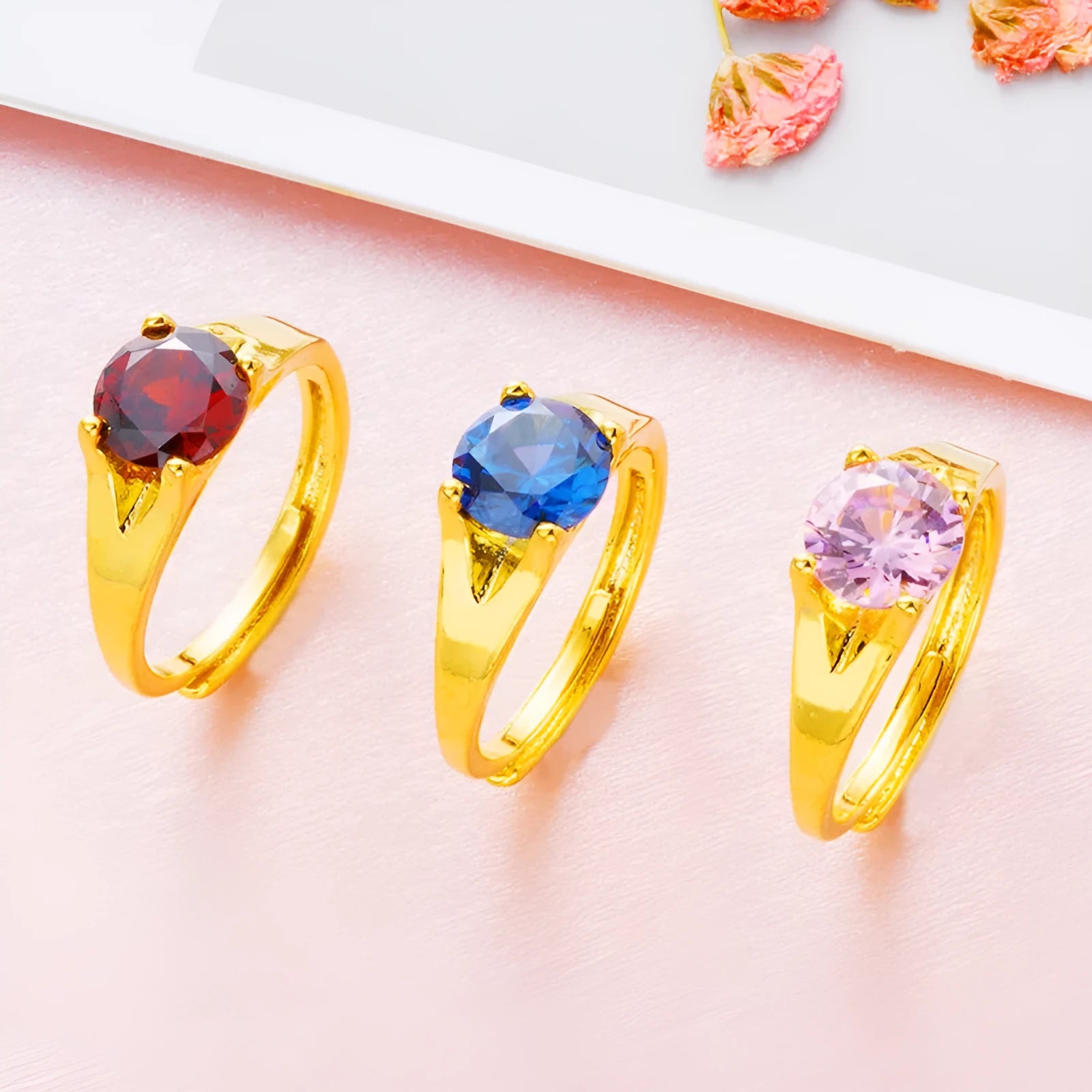 Women's adjustable copper ring with zircon stone in six colour options on a white background.