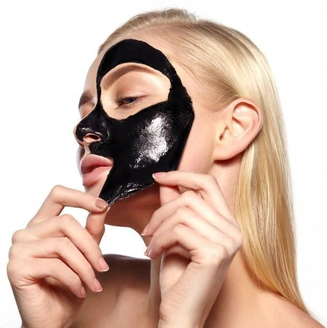 Deep cleansing black mask applied to nose for blackhead removal from pores