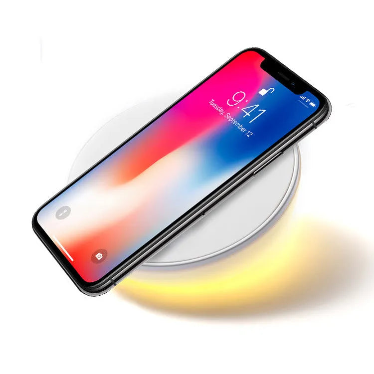 White wireless phone charger with LED digital clock display and three control buttons on the front.