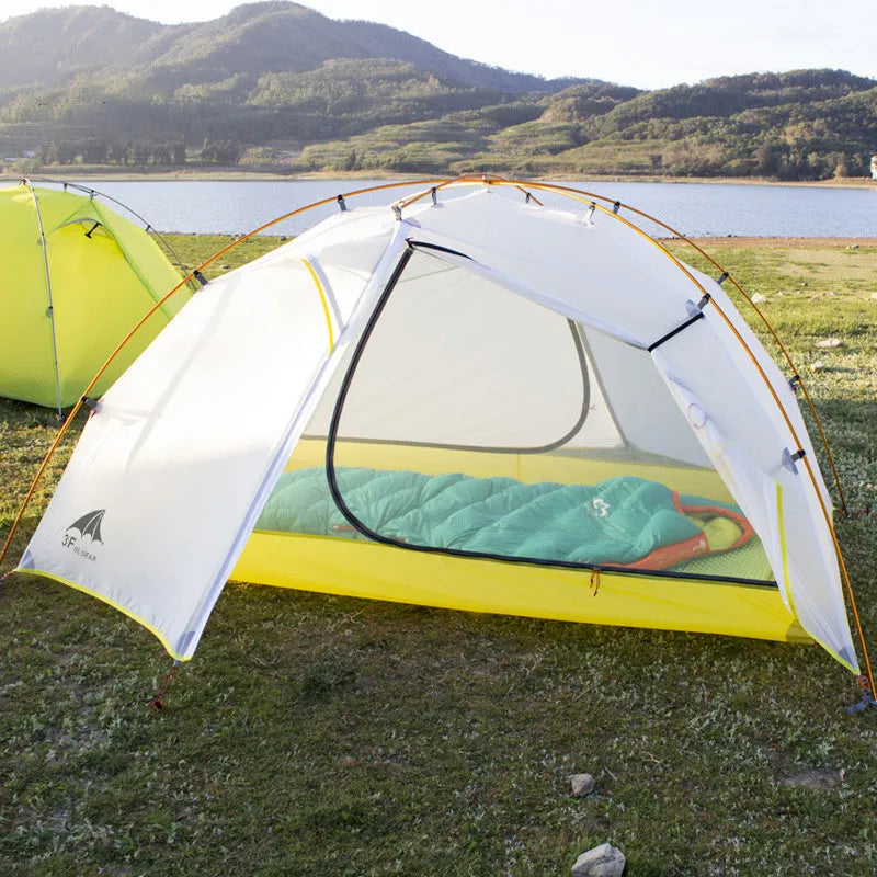 Double layer camping tent in dark green camouflage with two rooms and one hall, aluminium alloy poles, set up outdoors