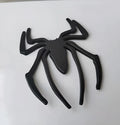 Three-dimensional metal spider bumper sticker in metallic finish.