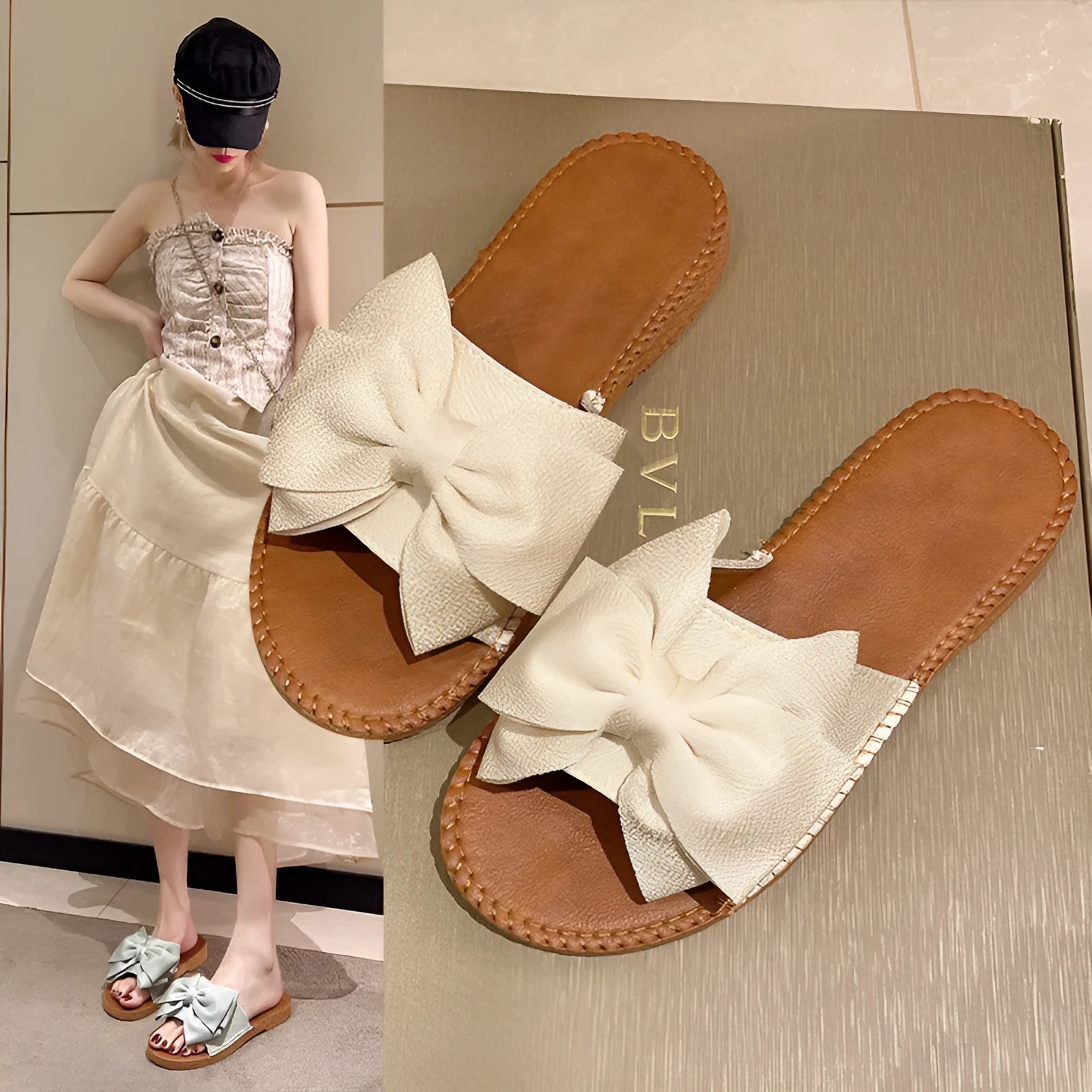 Women's beige suede slip-on sandals with a bow detail and a flat rubber sole.
