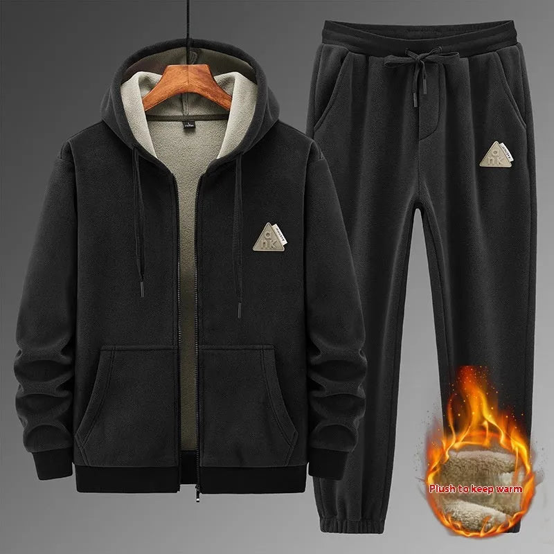 Man wearing a grey hooded cashmere sweater and matching cotton trousers from a casual sports suit set.