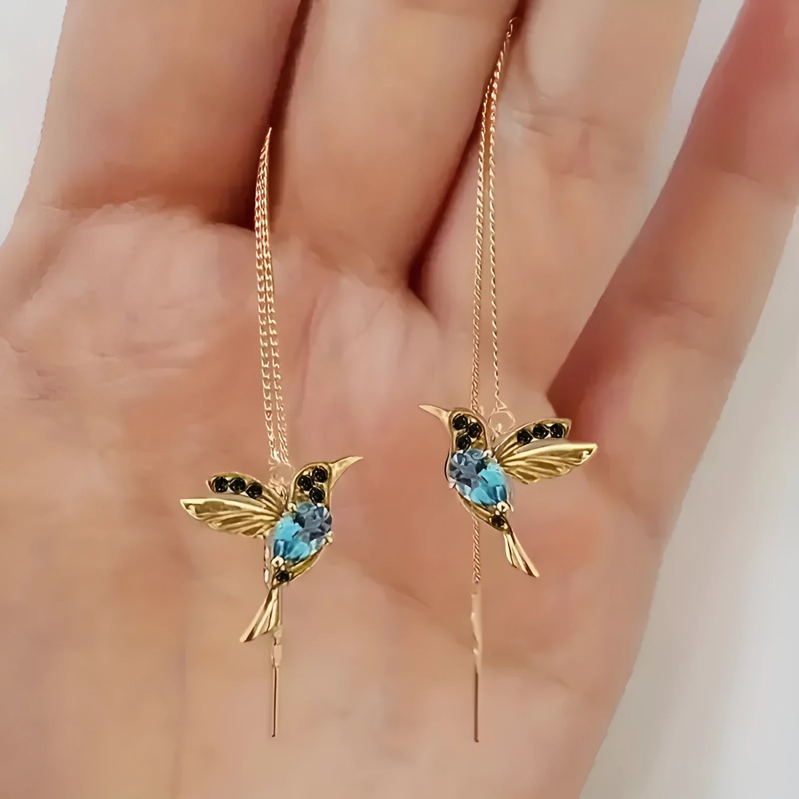 Long, dangling bird-shaped earrings with zirconium wing details in red, blue, and red lvzuan colour options.