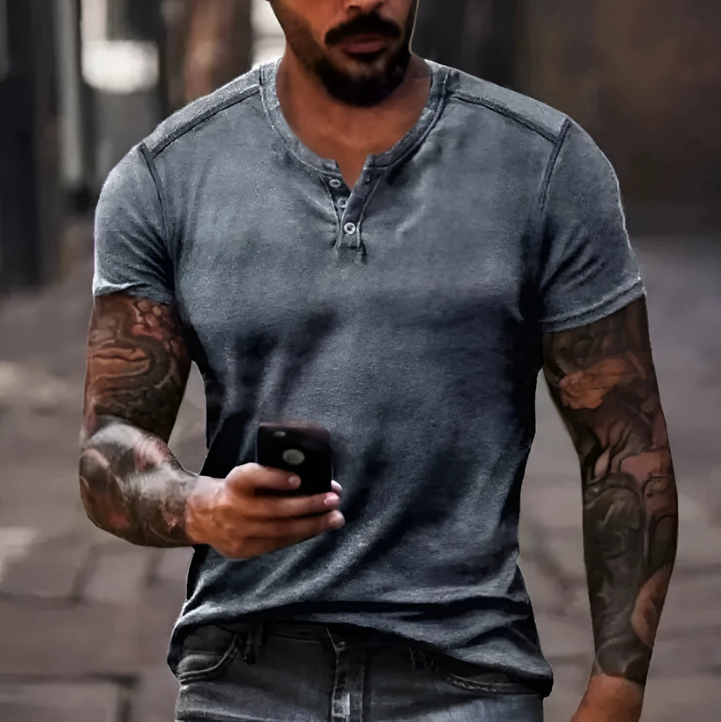 A man's short sleeve polo shirt in bird eye cloth with a simple lapel and button front, shown in a colour matching pattern.