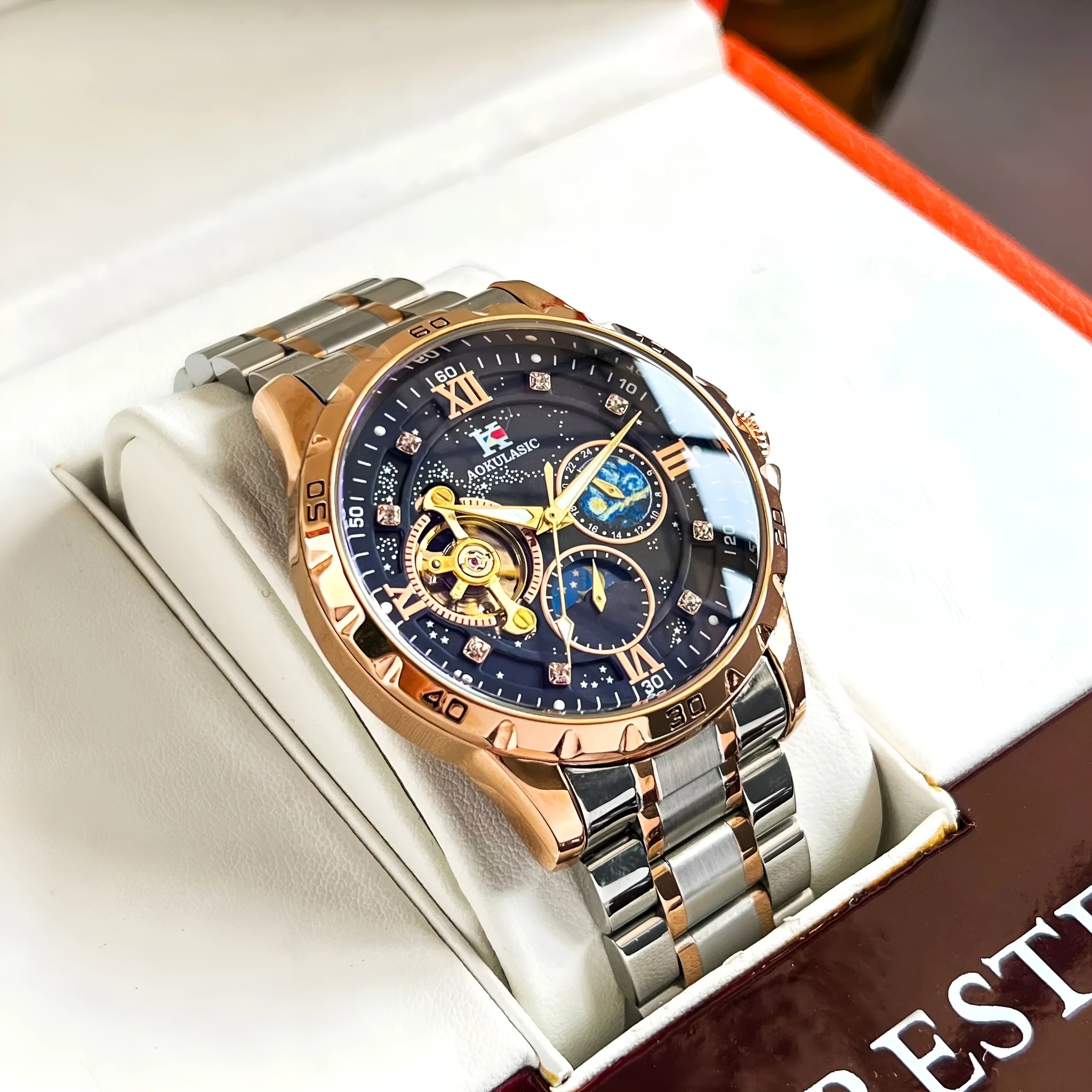 Automatic mechanical men's watch with rose gold case, black dial, and large day-date display.