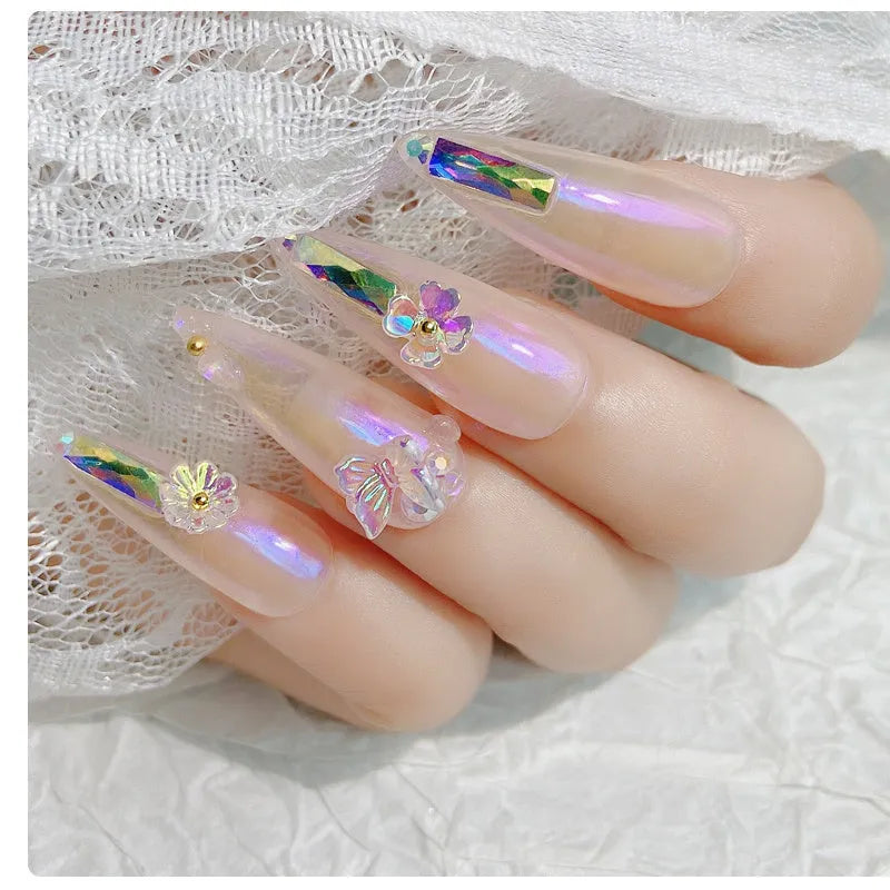 Container of flower and butterfly shaped nail sequins in mixed colours blue champagne grey pink transparent yellow
