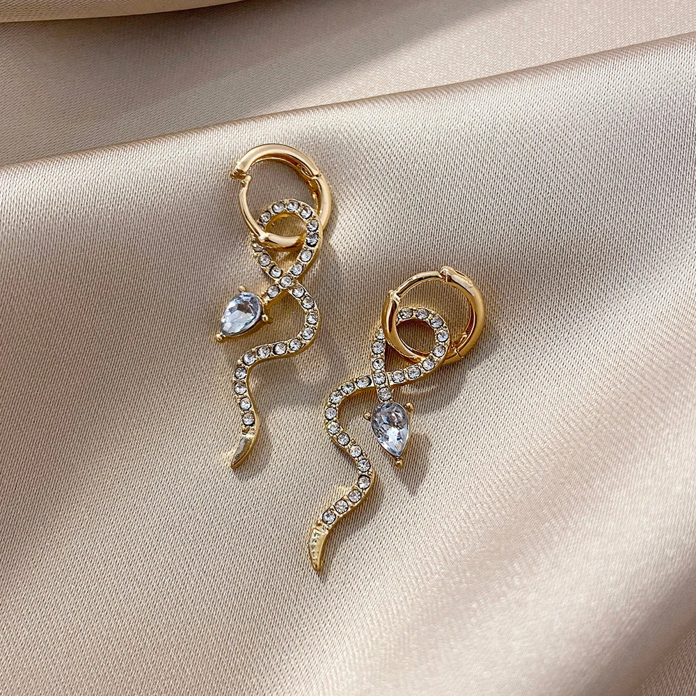 Elegant snake-shaped dangle earrings with a golden hue, showcasing a blend of European and American style