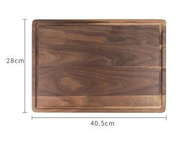 Black walnut wood cutting board with engraved handle and groove design for kitchen use