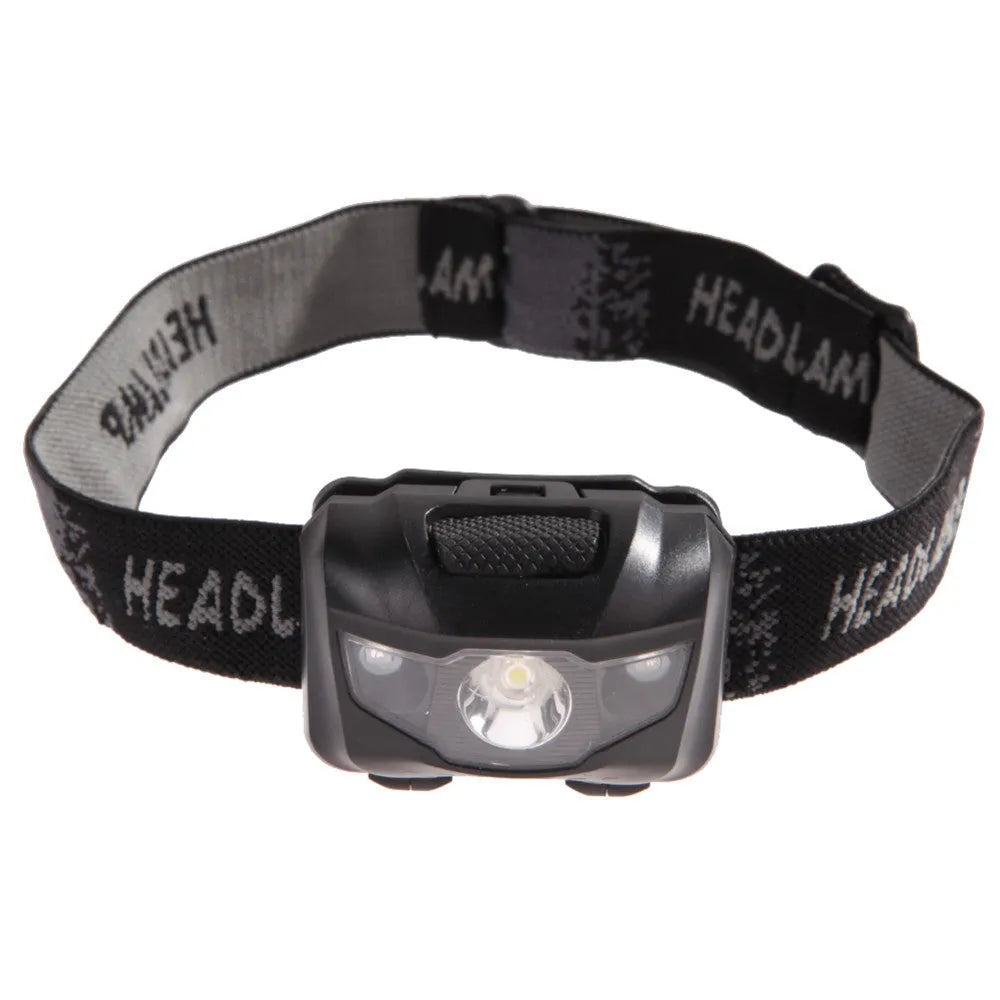 Black waterproof head torch with white and red LEDs, worn on head strap for outdoor activities.