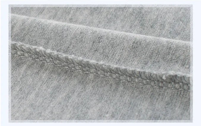 Grey cotton children's T-shirt laid flat, showing plain front and detailed size label.