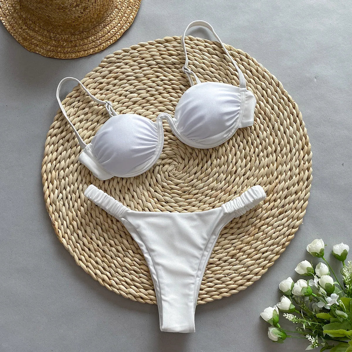 Women's black underwire bikini top and briefs set made from high elasticity nylon fabric.