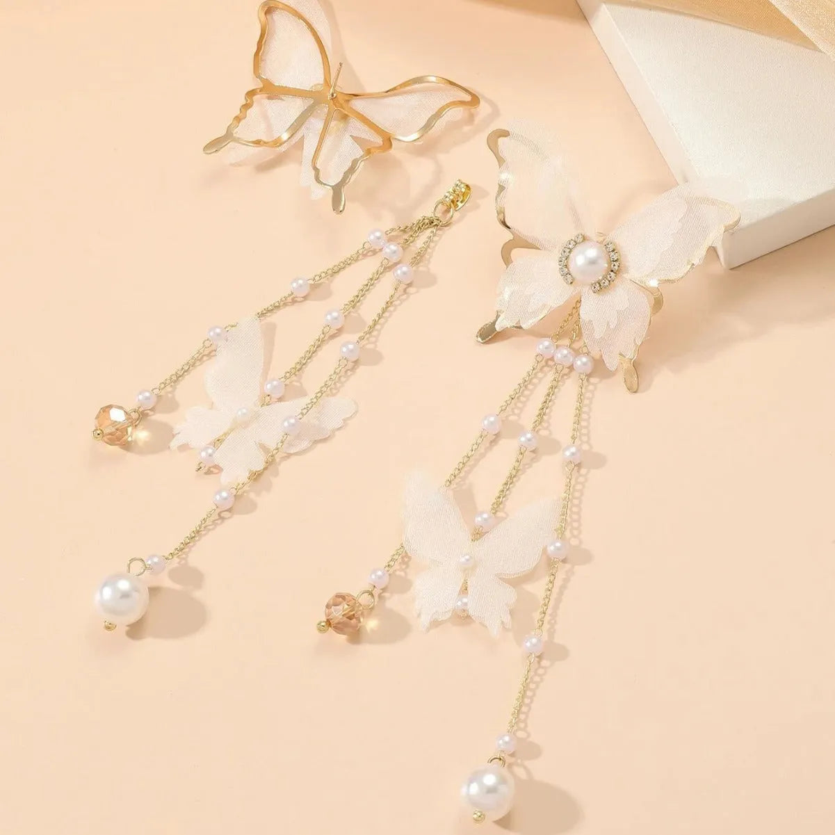 White butterfly earrings with lace tassel, pearl accents and rhinestones on copper alloy