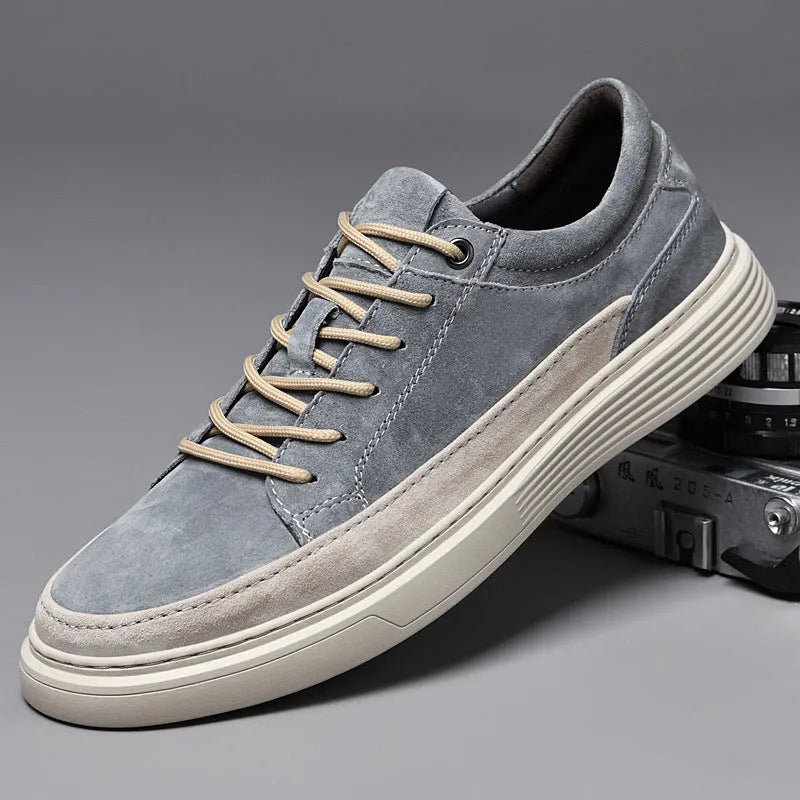 Men's grey pigskin leather low-top casual skate shoes with round toe and flat rubber sole.