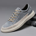 Men's grey pigskin leather low-top casual skate shoes with round toe and flat rubber sole.