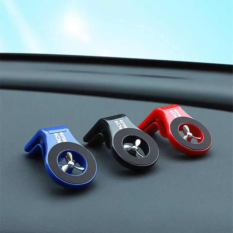 Magnetic car phone holder mounted on air vent with smartphone attached and fragrance slices
