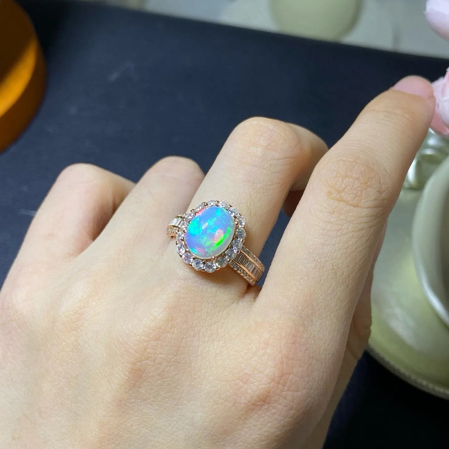 Handmade adjustable opal ring on a sterling silver open band with gold tone plating.