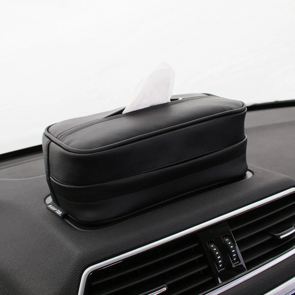 Black PU leather hanging storage box with paper bag design, shown suspended.