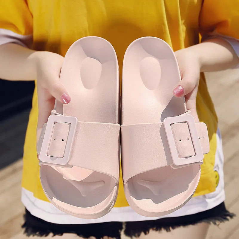 Women's grey blue buckle slipper with adjustable strap and soft EVA sole.