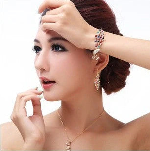 Creative Crystal Peacock Bridal Jewelry Set showing earrings, necklace, and bracelet with alloy construction and crystal accents