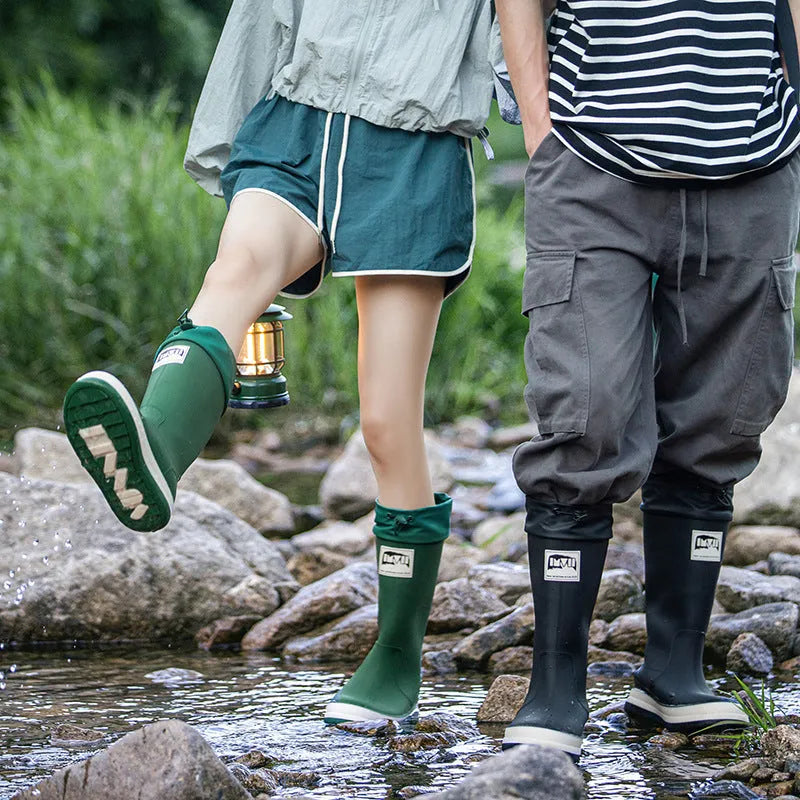 Pair of solid-colour high-tube PVC rain boots with a non-slip sole on a neutral background.