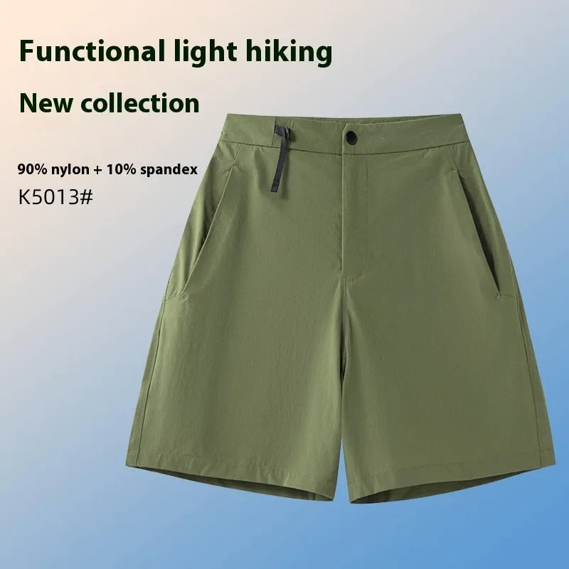 Man wearing khaki quick-dry sports shorts with four-way stretch on a running track.