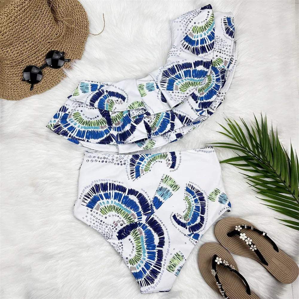 White one-shoulder women's swimsuit with double-layer fabric and large lotus leaf hem detail.