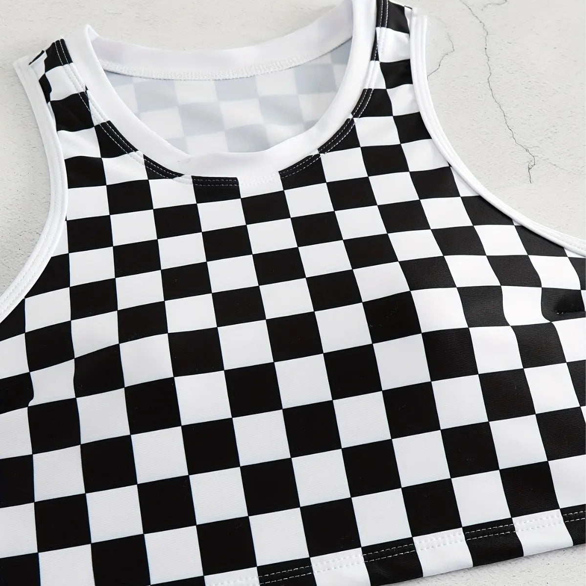Women's black and white chessboard plaid racing one-piece swimsuit with a suspender backless design.