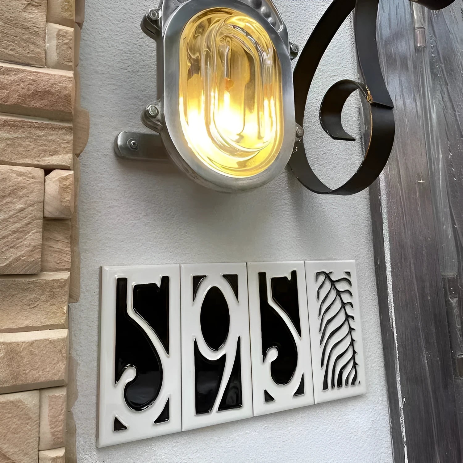 Handmade ceramic retro doorplate with enamel art number on a dark background.