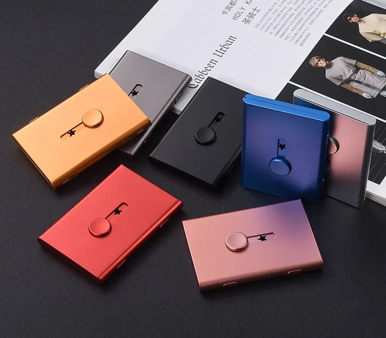 Hand push aluminium business card case in silver shown open with cards and internal layers visible