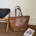 Fashionable large-capacity vintage tote bag in soft PU with stitched seams, horizontal shape, double straps