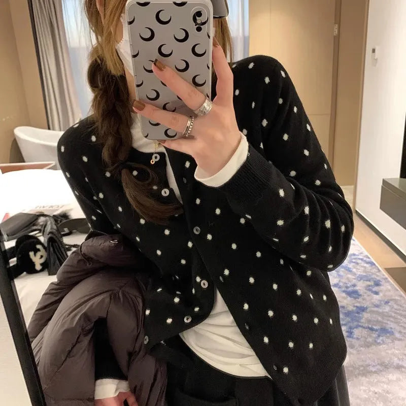 Women's loose grey knitted cardigan with crocheted dot flowers, long sleeves.