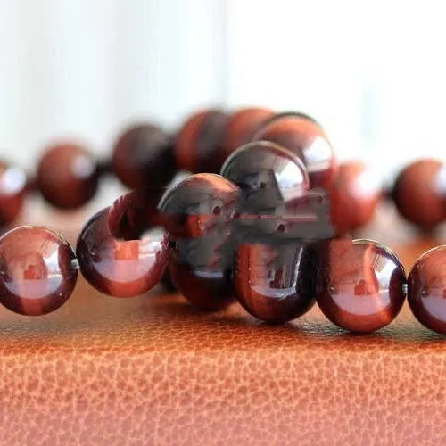 Red wood alexandrite bracelet with lightning cat's eye pattern and geometric beads